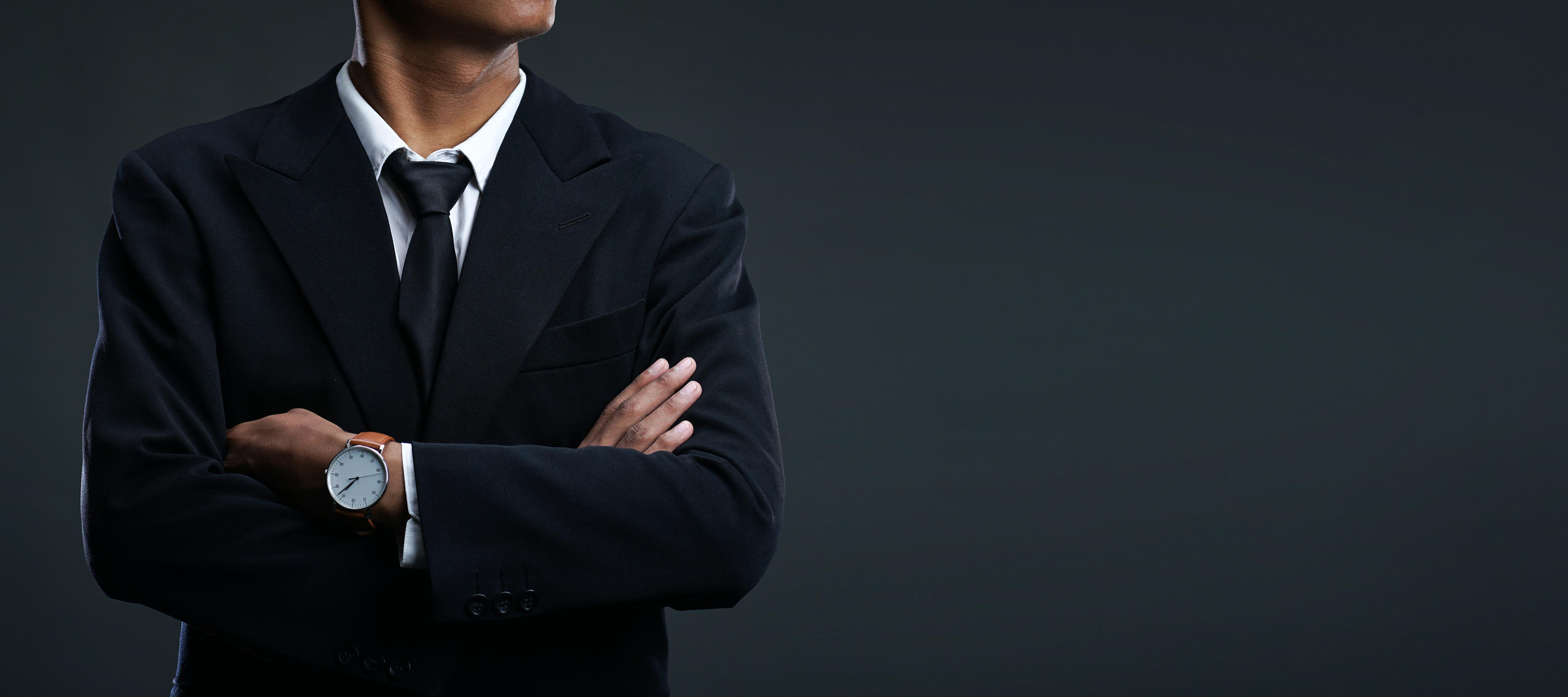 Man Wearing Suit and Tie has Arms Crossed 